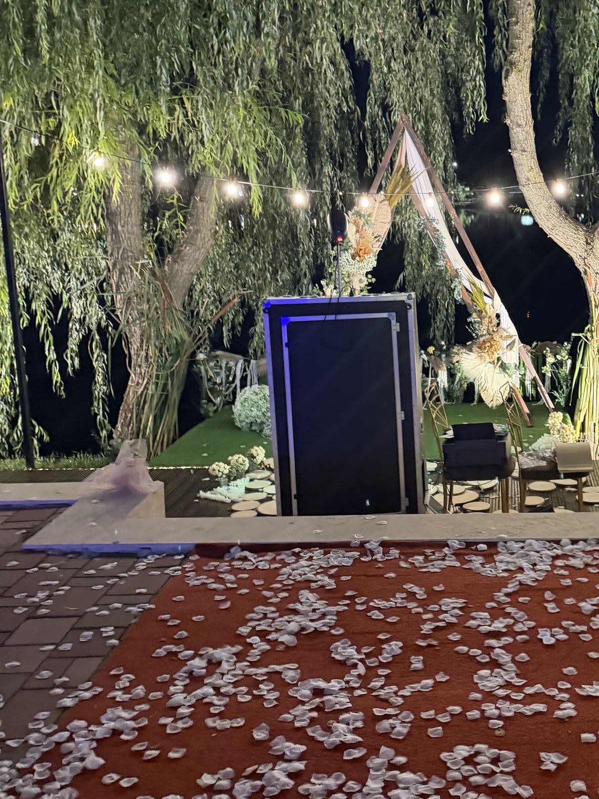 Cabina foto la capătul covorului cu petale, seara, la locația de la lac.